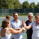 Community tennis club members celebrating a point